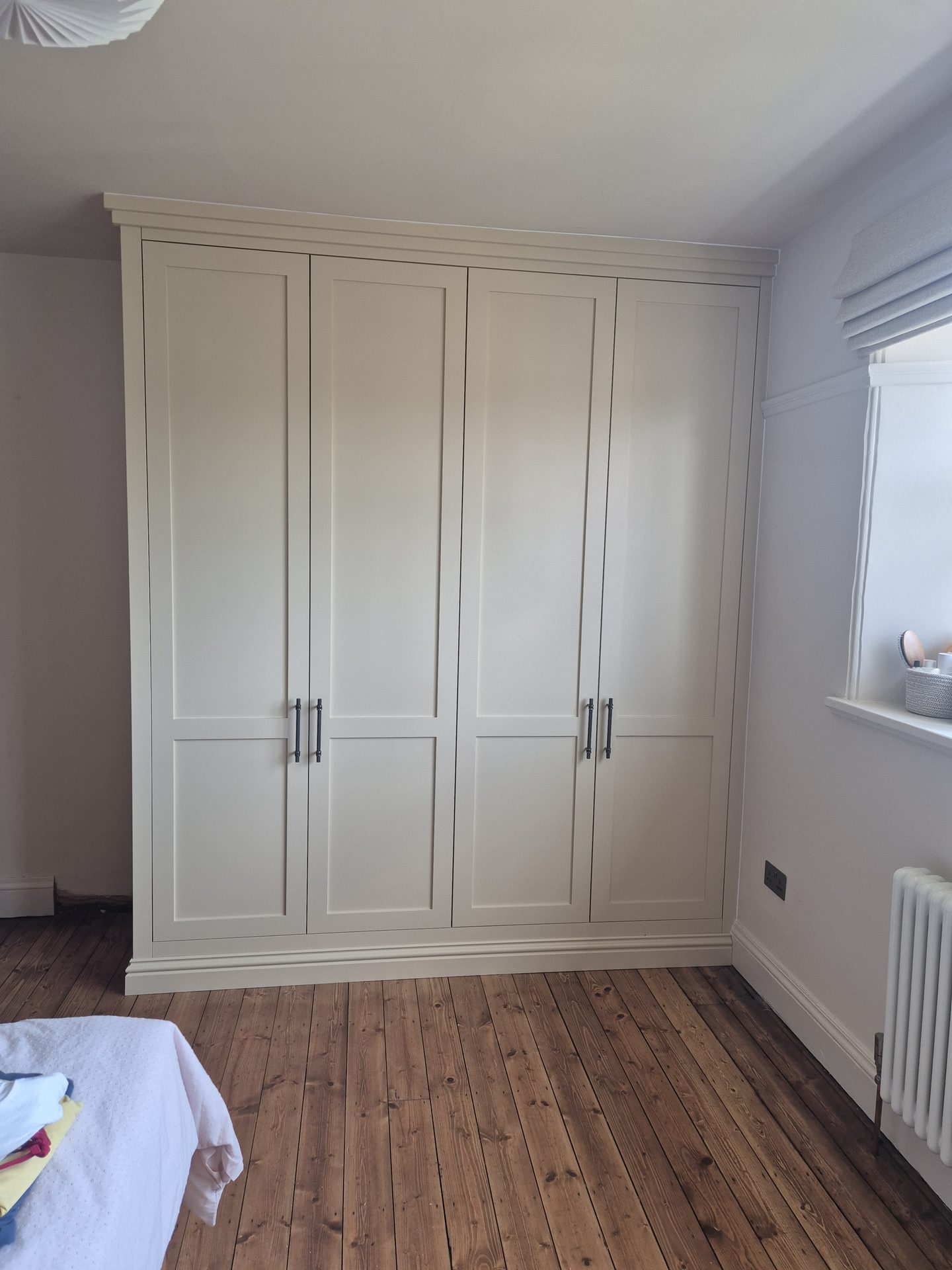Cream fitted wardrobes with classic panelled doors